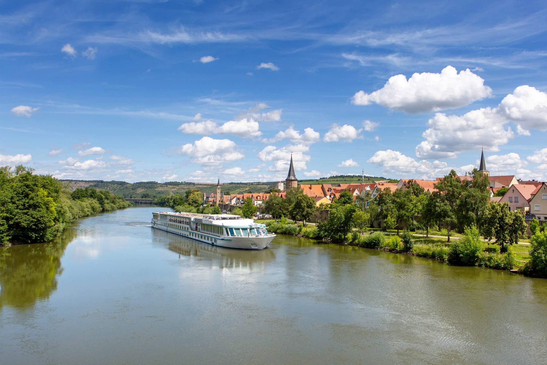 River cruise ship in scenic landscape