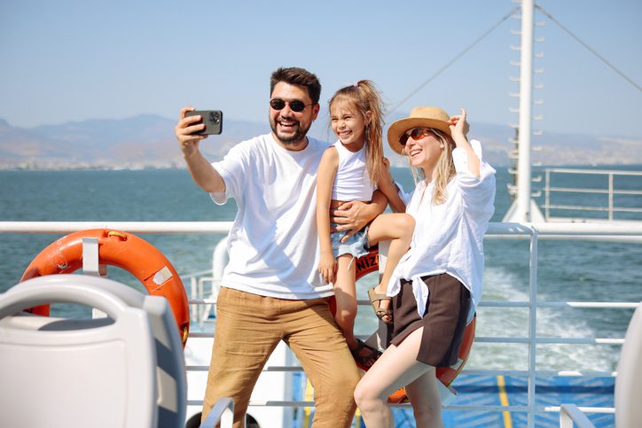 Parents and child smiling on deck